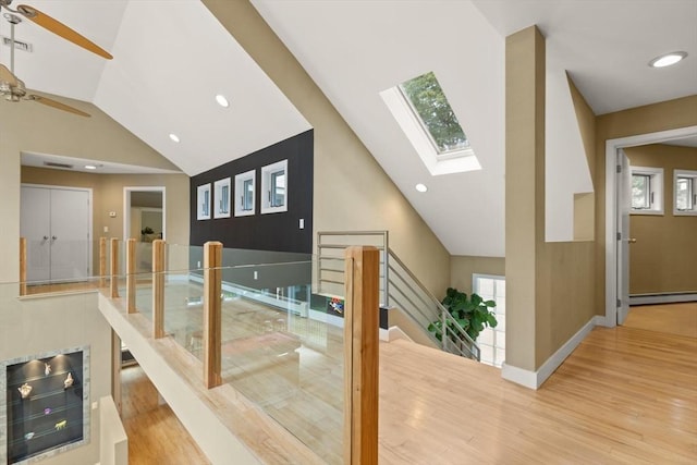 28 Elm St, Berkley, MA 02779 - stairway with a skylight, wood finished floors, a baseboard radiator, ceiling fan, and high vaulted ceiling