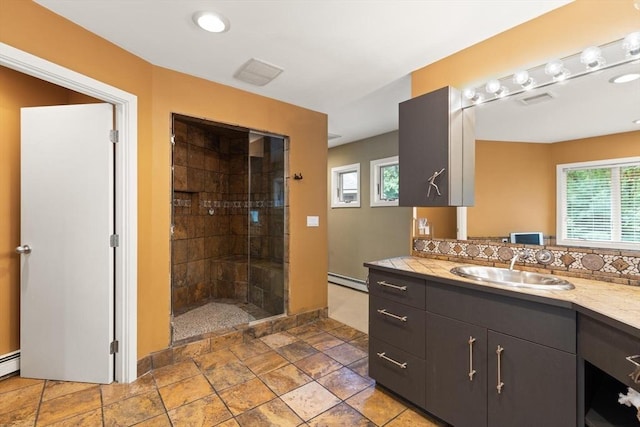 28 Elm St, Berkley, MA 02779 - bathroom featuring vanity, tiled shower, baseboard heating, decorative backsplash, and stone finish floors