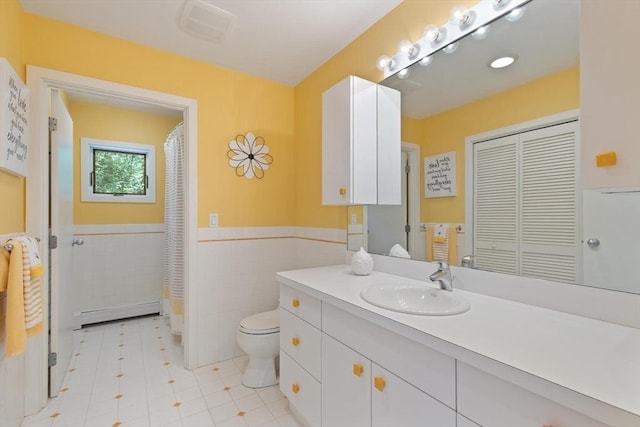 28 Elm St, Berkley, MA 02779 - bathroom featuring a baseboard radiator, tile walls, vanity, a wainscoted wall, and a closet