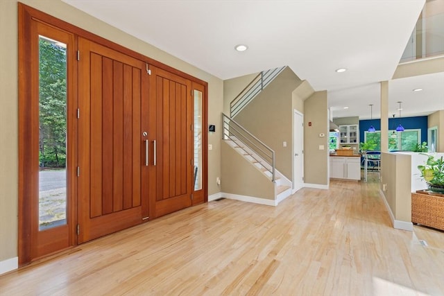 28 Elm St, Berkley, MA 02779 - foyer entrance featuring light wood-style floors, healthy amount of natural light, stairway, and recessed lighting