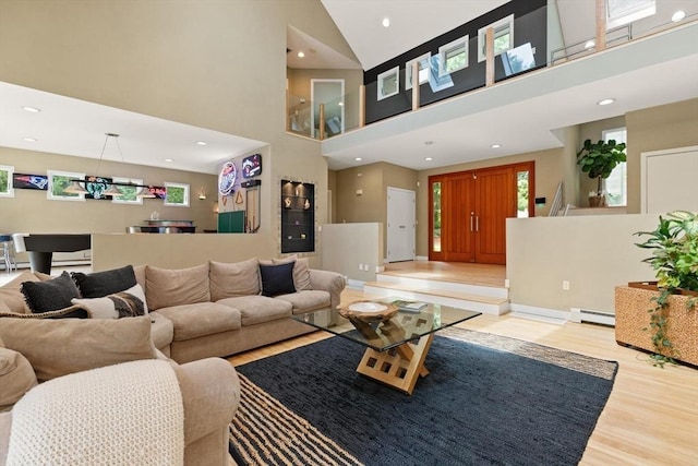 28 Elm St, Berkley, MA 02779 - living area featuring a baseboard heating unit, wood finished floors, a towering ceiling, and recessed lighting
