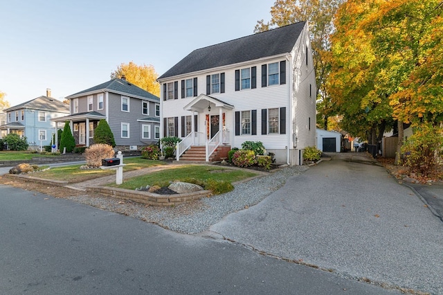 view of front of house with a garage and an outdoor structure