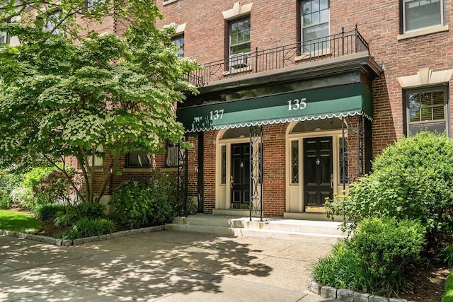 137 Freeman St Unit 3A, Brookline, MA 02446 - doorway to property featuring brick siding and a balcony