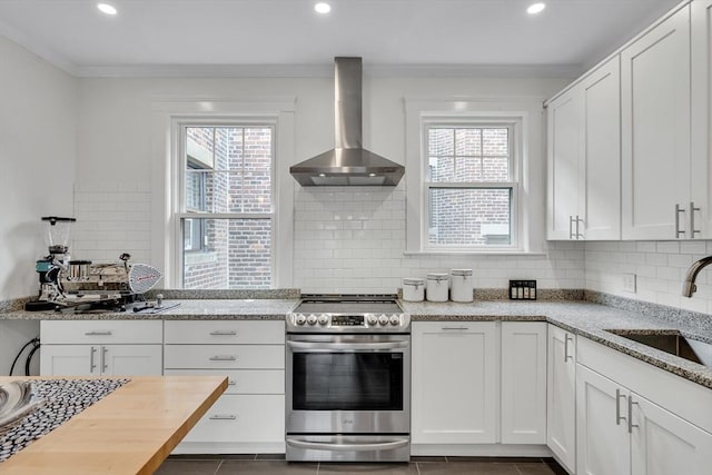 137 Freeman St Unit 3A, Brookline, MA 02446 - kitchen with wall chimney exhaust hood, stainless steel electric range oven, a sink, plenty of natural light, and crown molding