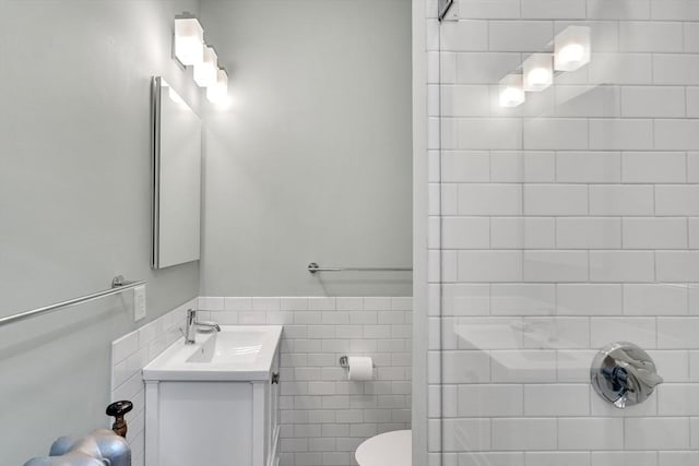 137 Freeman St Unit 3A, Brookline, MA 02446 - full bathroom with a tile shower, vanity, toilet, and tile walls