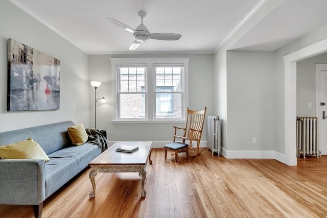 137 Freeman St Unit 3A, Brookline, MA 02446 - living room featuring radiator heating unit, wood finished floors, a ceiling fan, crown molding, and baseboards