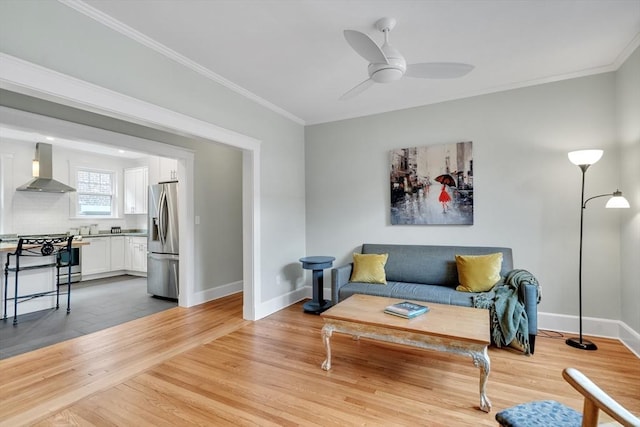 137 Freeman St Unit 3A, Brookline, MA 02446 - living room featuring ceiling fan, baseboards, light wood-style floors, and ornamental molding