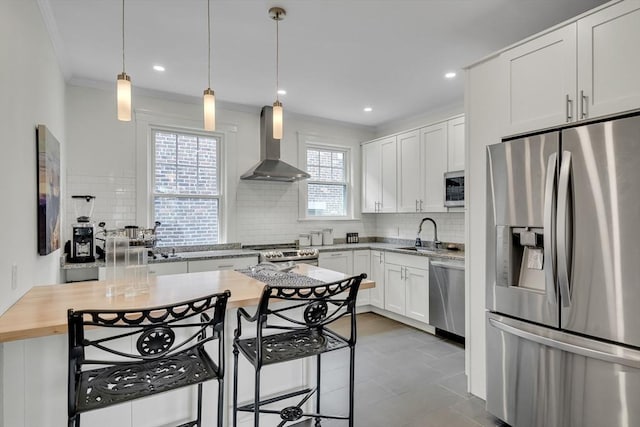 137 Freeman St Unit 3A, Brookline, MA 02446 - kitchen with appliances with stainless steel finishes, wall chimney range hood, a sink, tasteful backsplash, and white cabinets