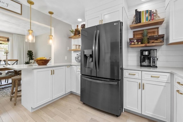 27 Harnden Rd, Billerica, MA 01821 - kitchen featuring black fridge, open shelves, a peninsula, white cabinets, and light wood finished floors