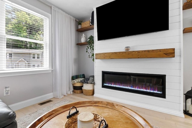 27 Harnden Rd, Billerica, MA 01821 - living area with a fireplace, healthy amount of natural light, wood finished floors, and baseboards