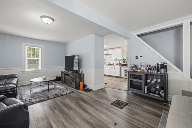 25 Bayley Ter, Weymouth, MA 02190 - living area featuring a wainscoted wall and wood finished floors