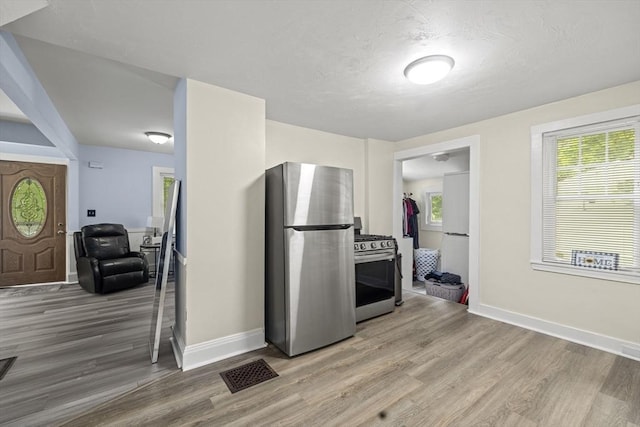 25 Bayley Ter, Weymouth, MA 02190 - kitchen with stainless steel appliances, light wood finished floors, and baseboards
