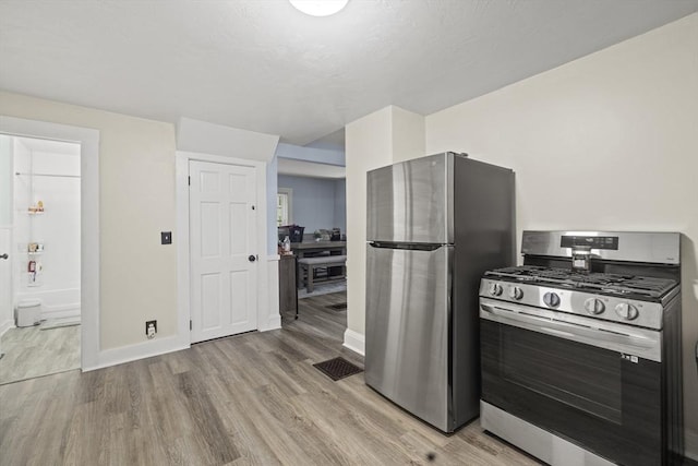 25 Bayley Ter, Weymouth, MA 02190 - kitchen featuring appliances with stainless steel finishes, light wood finished floors, and baseboards