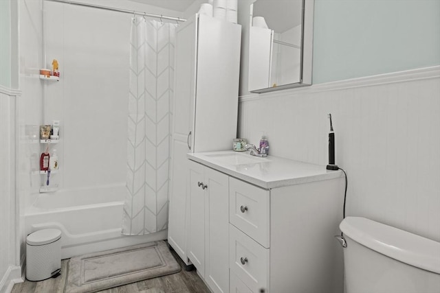 25 Bayley Ter, Weymouth, MA 02190 - full bathroom featuring toilet, wood finished floors, vanity, shower / bath combo with shower curtain, and wainscoting