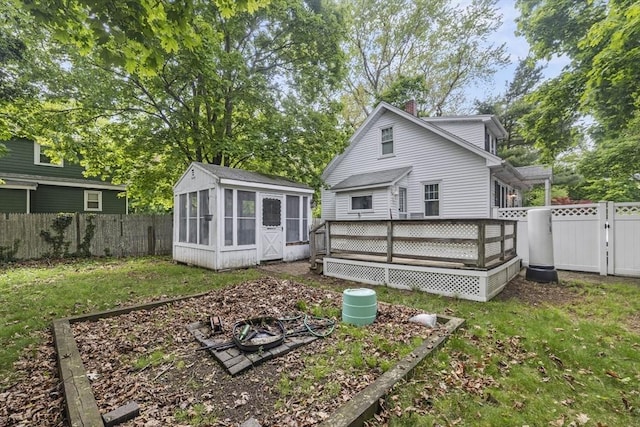 25 Bayley Ter, Weymouth, MA 02190 - rear view of property with a sunroom, a wooden deck, a fire pit, a chimney, and a gate