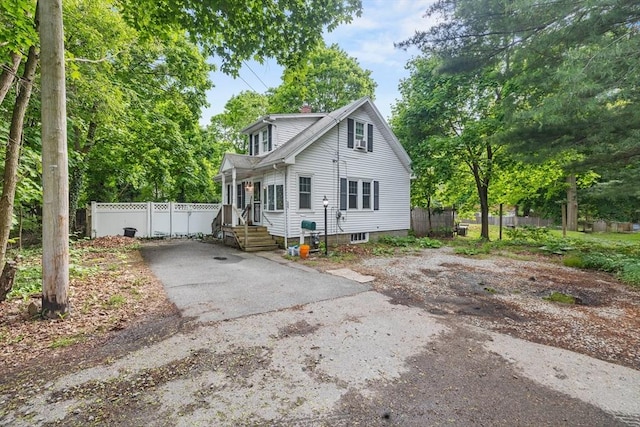 25 Bayley Ter, Weymouth, MA 02190 - view of front of property featuring asphalt driveway, fence, and a chimney