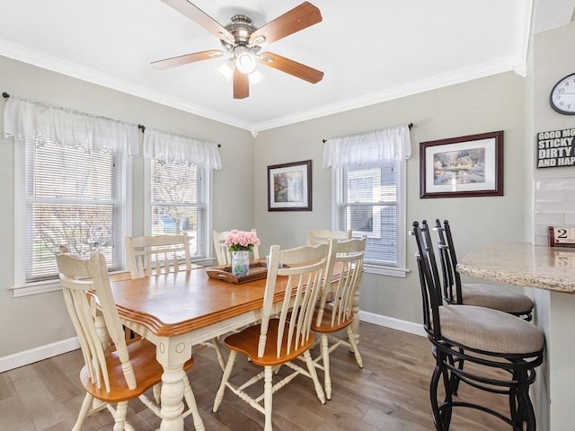 55 Bruce Rd, Waltham, MA 02453 - dining room featuring plenty of natural light, ornamental molding, wood finished floors, ceiling fan, and baseboards