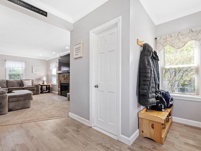 55 Bruce Rd, Waltham, MA 02453 - mudroom with light wood-style floors, crown molding, baseboards, a stone fireplace, and recessed lighting