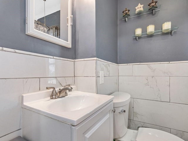 55 Bruce Rd, Waltham, MA 02453 - half bath featuring toilet, tile walls, and vanity