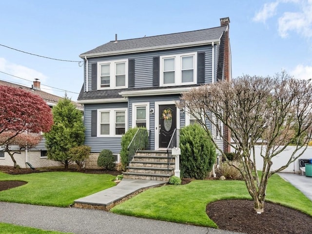 55 Bruce Rd, Waltham, MA 02453 - dutch colonial featuring a front lawn, a chimney, and roof with shingles