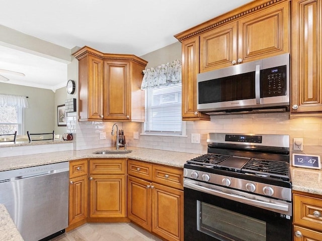 55 Bruce Rd, Waltham, MA 02453 - kitchen with appliances with stainless steel finishes, a sink, brown cabinetry, light stone counters, and crown molding