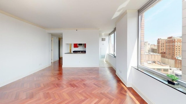 unfurnished living room with ornamental molding, parquet floors, and a healthy amount of sunlight