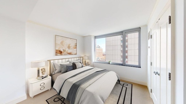 bedroom with crown molding and light carpet