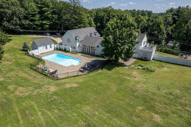 view of swimming pool with an outbuilding, a lawn, and a patio