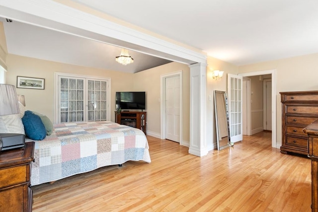 bedroom with an inviting chandelier and light hardwood / wood-style floors