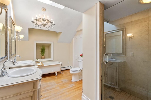 full bathroom with an inviting chandelier, shower with separate bathtub, baseboard heating, vanity, and hardwood / wood-style flooring