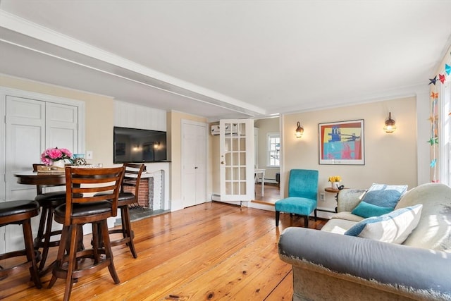 living room with a baseboard radiator and light wood-type flooring