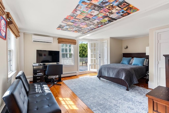 bedroom with hardwood / wood-style floors, a baseboard radiator, ornamental molding, access to exterior, and a wall unit AC