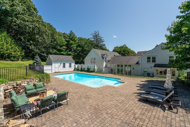 view of swimming pool with an outdoor structure and a patio