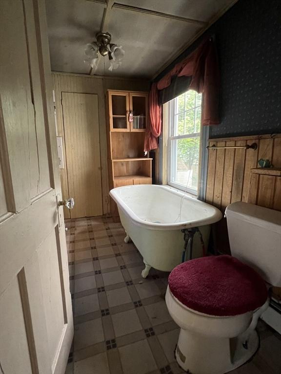 7 Little River St, Haverhill, MA 01832 - full bath with toilet, wallpapered walls, wooden walls, tile patterned floors, and a freestanding tub