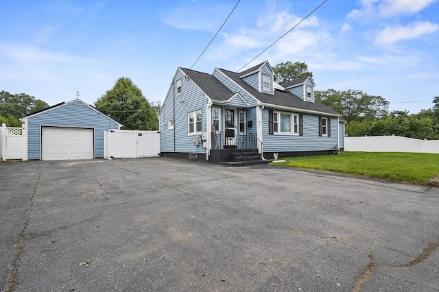 51 Crystal St, Lowell, MA 01852 - view of front facade with a detached garage, a gate, and asphalt driveway