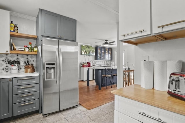 51 Crystal St, Lowell, MA 01852 - kitchen with stainless steel fridge with ice dispenser, ceiling fan, backsplash, light tile patterned floors, and gray cabinetry