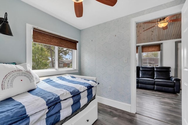 242 Old Wharf Rd Unit B4, Dennis, MA 02639 - bedroom with wallpapered walls, baseboards, dark wood finished floors, and ceiling fan