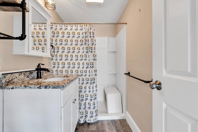 242 Old Wharf Rd Unit B4, Dennis, MA 02639 - full bath featuring vanity, curtained shower, wood finished floors, and baseboards