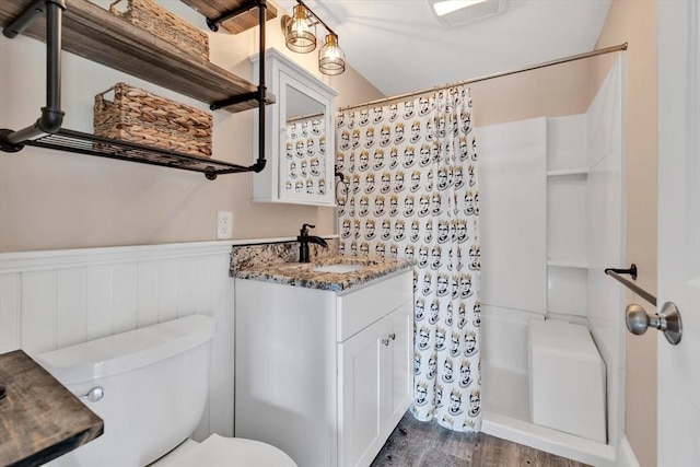 242 Old Wharf Rd Unit B4, Dennis, MA 02639 - bathroom featuring wainscoting, wood finished floors, vanity, and toilet