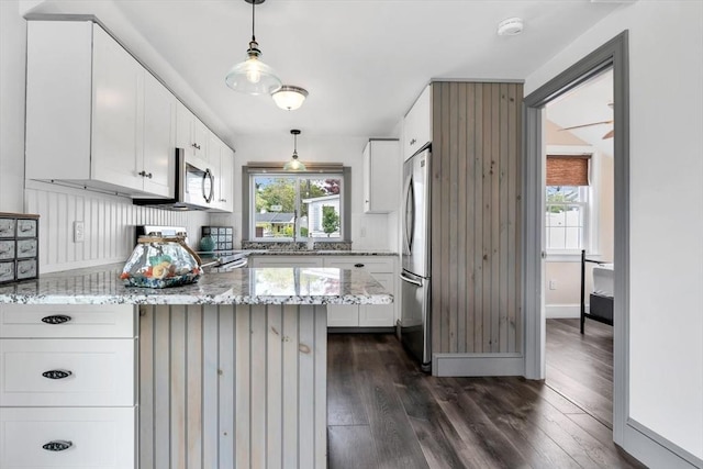 242 Old Wharf Rd Unit B4, Dennis, MA 02639 - kitchen featuring appliances with stainless steel finishes, a peninsula, dark wood-type flooring, and light stone counters