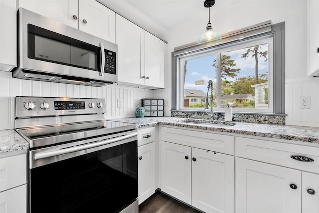 242 Old Wharf Rd Unit B4, Dennis, MA 02639 - kitchen with stainless steel appliances, a sink, white cabinetry, and light stone countertops