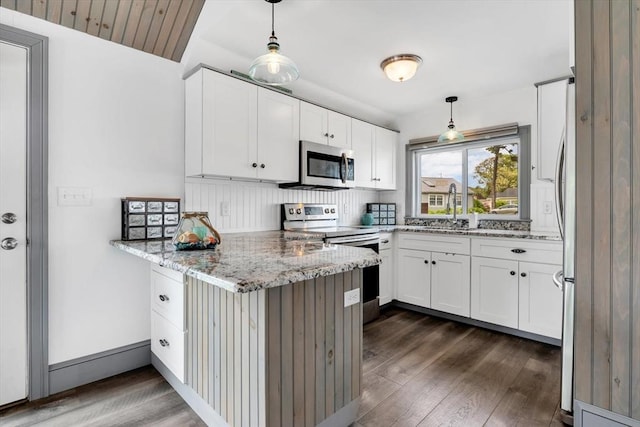 242 Old Wharf Rd Unit B4, Dennis, MA 02639 - kitchen with appliances with stainless steel finishes, a peninsula, dark wood-style floors, a sink, and white cabinets