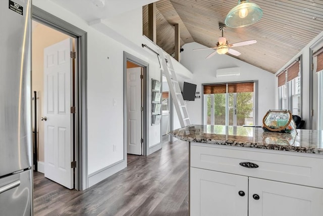 242 Old Wharf Rd Unit B4, Dennis, MA 02639 - kitchen with stainless steel fridge, a wall unit AC, wooden ceiling, a ceiling fan, and stone countertops