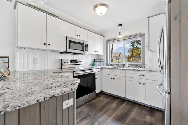 242 Old Wharf Rd Unit B4, Dennis, MA 02639 - kitchen with appliances with stainless steel finishes, dark wood finished floors, a sink, and light stone counters