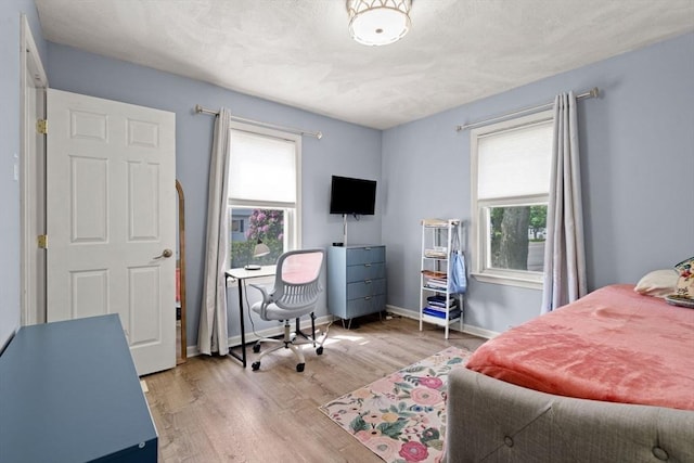 65 Holten St, Danvers, MA 01923 - bedroom with multiple windows, wood finished floors, an office area, and baseboards