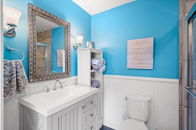 65 Holten St, Danvers, MA 01923 - bathroom featuring wainscoting, a stall shower, vanity, and toilet