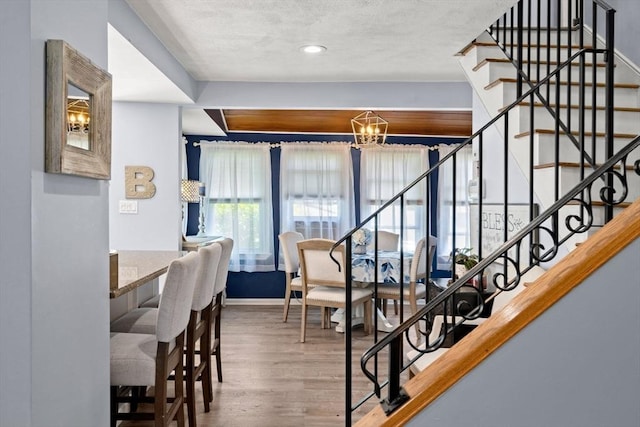 65 Holten St, Danvers, MA 01923 - stairway with wood finished floors, a chandelier, baseboards, a textured ceiling, and recessed lighting