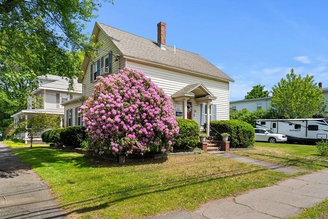 65 Holten St, Danvers, MA 01923 - view of front of home featuring a front lawn and a chimney