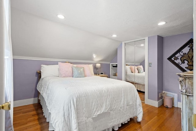 65 Holten St, Danvers, MA 01923 - bedroom featuring baseboards, lofted ceiling, a closet, wood finished floors, and recessed lighting