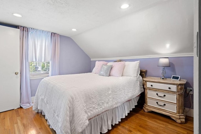 65 Holten St, Danvers, MA 01923 - bedroom with wood finished floors, lofted ceiling, a textured ceiling, and recessed lighting